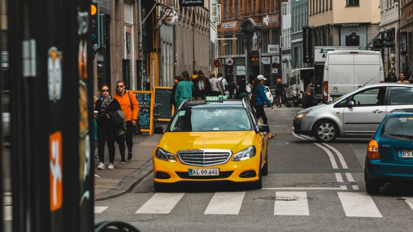 Street with yellow taxi.