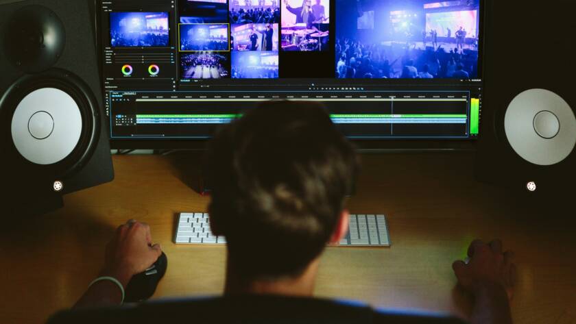 A guy doing video editing on his computer.