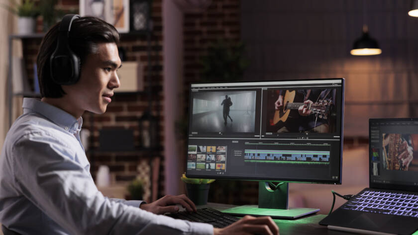 A guy video editing on his computer.